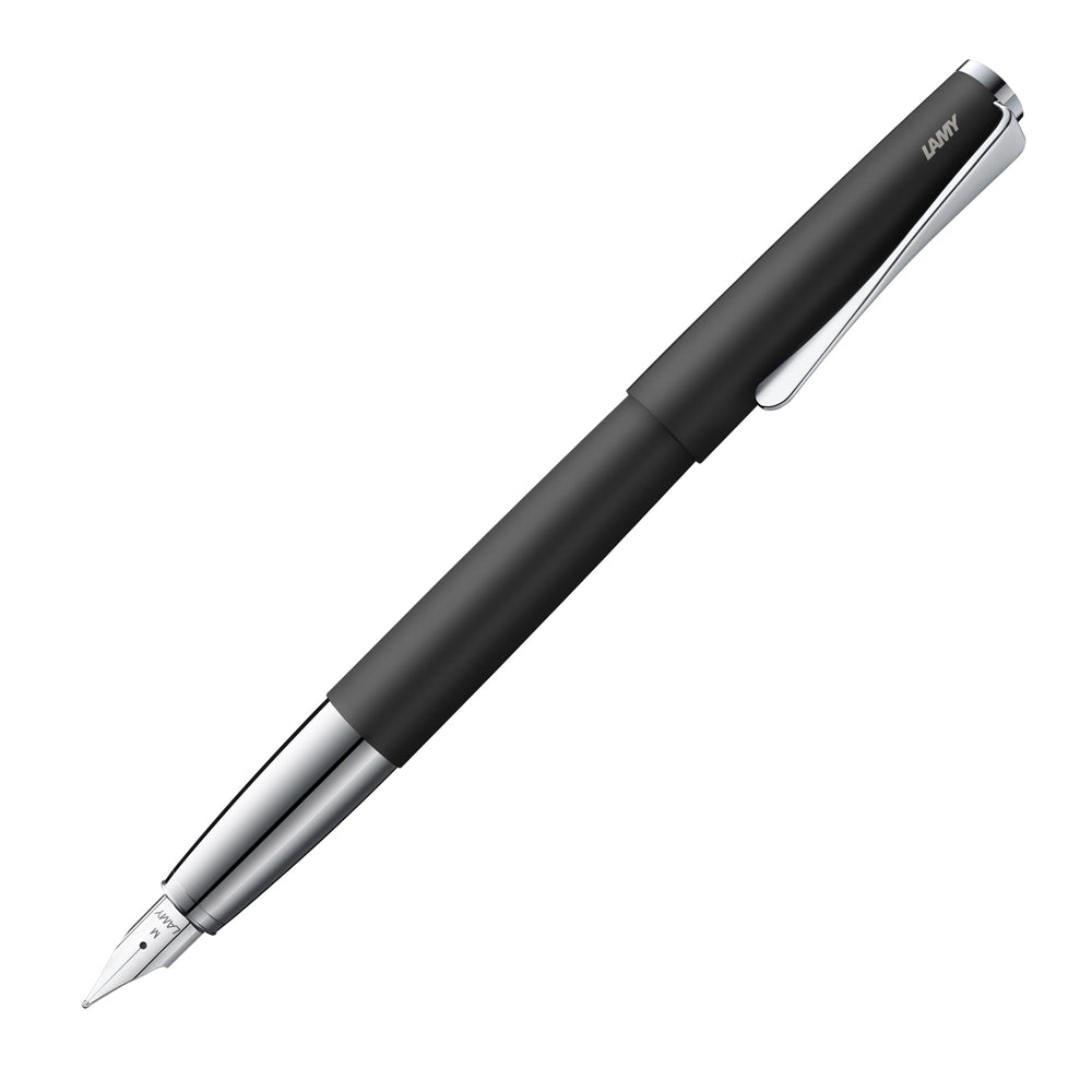 Un stylo plume Lamy Studio 067 en finition noir mat, incliné à 45 degrés avec le bouchon retiré, est présenté sur un fond blanc. Ce stylo plume se distingue par son design élégant et moderne avec une finition noir mat sophistiquée, offrant une expérience d'écriture raffinée.
