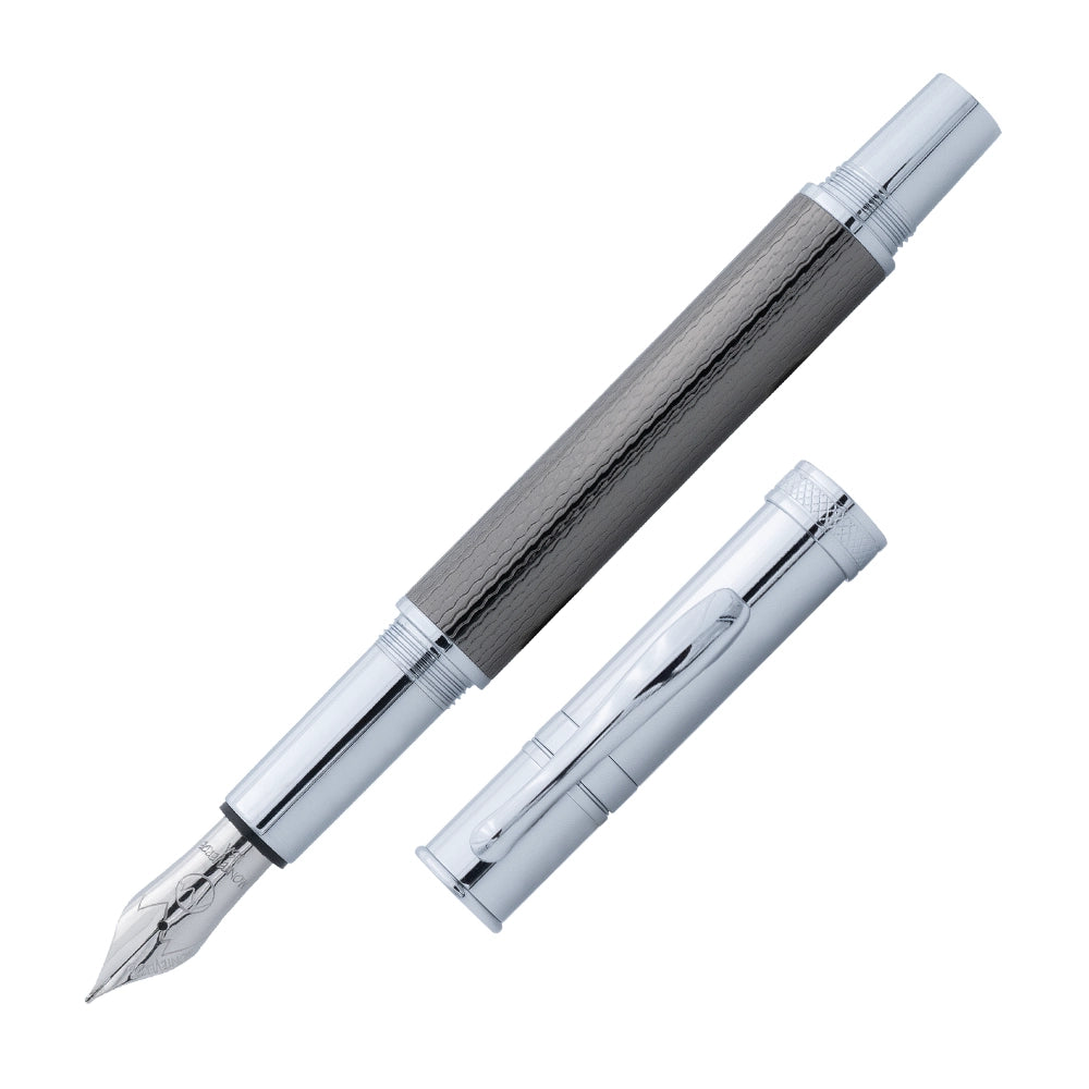 Un stylo plume Monteverde Jewelria Executive en finition gun metal barley, incliné à 45 degrés avec le bouchon retiré, est présenté sur un fond blanc. Le stylo plume est élégant avec une finition en métal gunny, et un design moderne et raffiné.